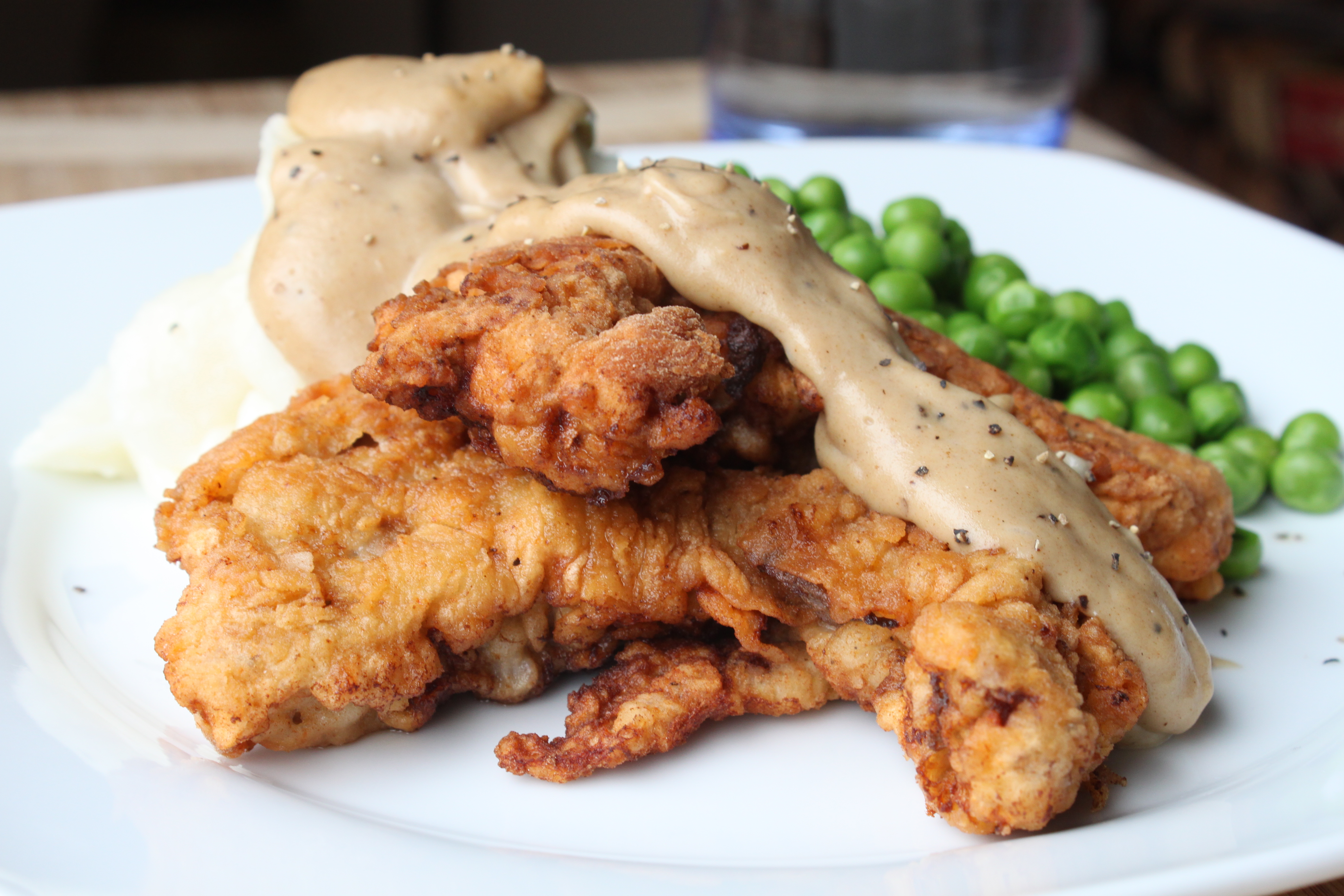 Chicken Fried Steak Fingers with Mashed Potatoes, Gravy and Peas.